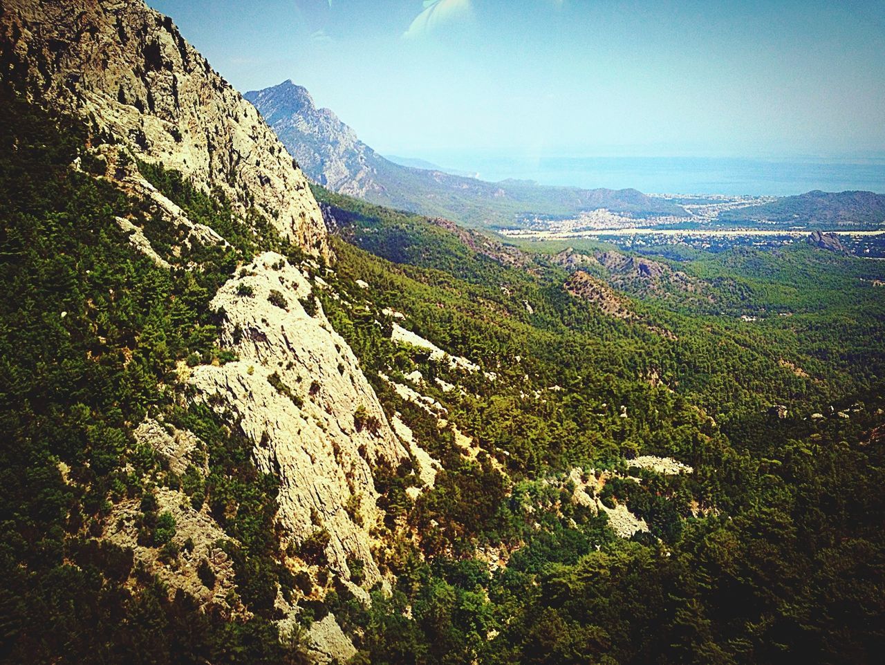 mountain, tranquil scene, tranquility, scenics, beauty in nature, landscape, nature, mountain range, non-urban scene, idyllic, sky, clear sky, remote, day, high angle view, blue, sunlight, tree, outdoors, no people