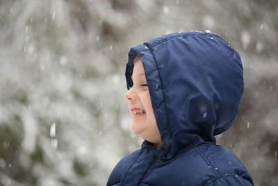 Portrait of boy standing in snow