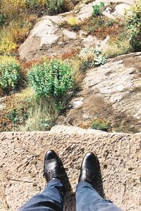 Low section of man standing on rock