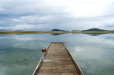 Pier over lake against sky