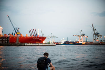 Rear view of cranes at commercial dock