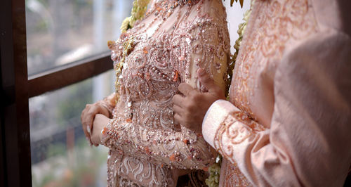 Midsection of bride and groom