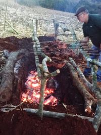 View of man with fire hydrant on log