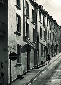 Rear view of man walking on street in city