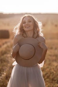 Portrait of young woman sitting at beach