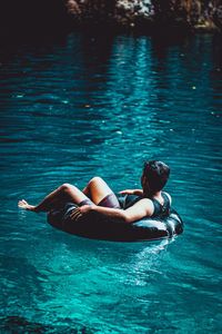 Man lying in swimming pool