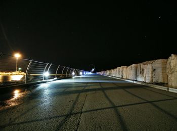 Illuminated tunnel at night