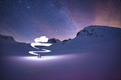 Light painting on snow covered land at night