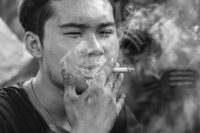 Portrait of man smoking cigarette