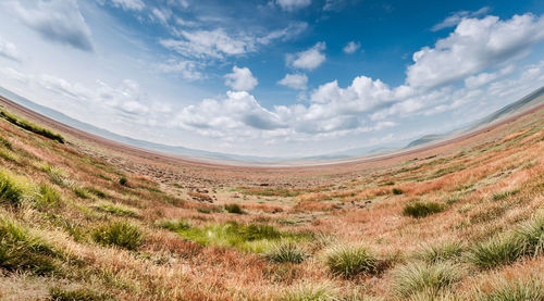 Scenic view of sand dunes against sky