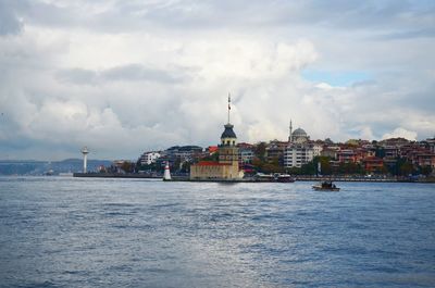 View of sea and buildings against sky