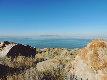 Scenic view of sea against clear blue sky