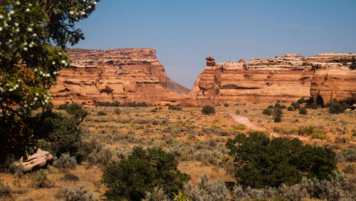 Rock formations on landscape against clear sky