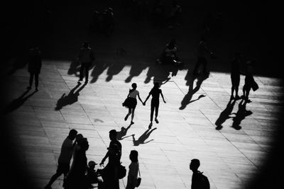 High angle view of silhouette people walking on zebra crossing