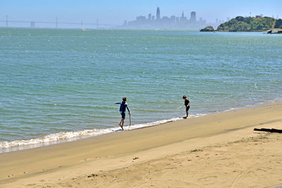 People on beach against sky