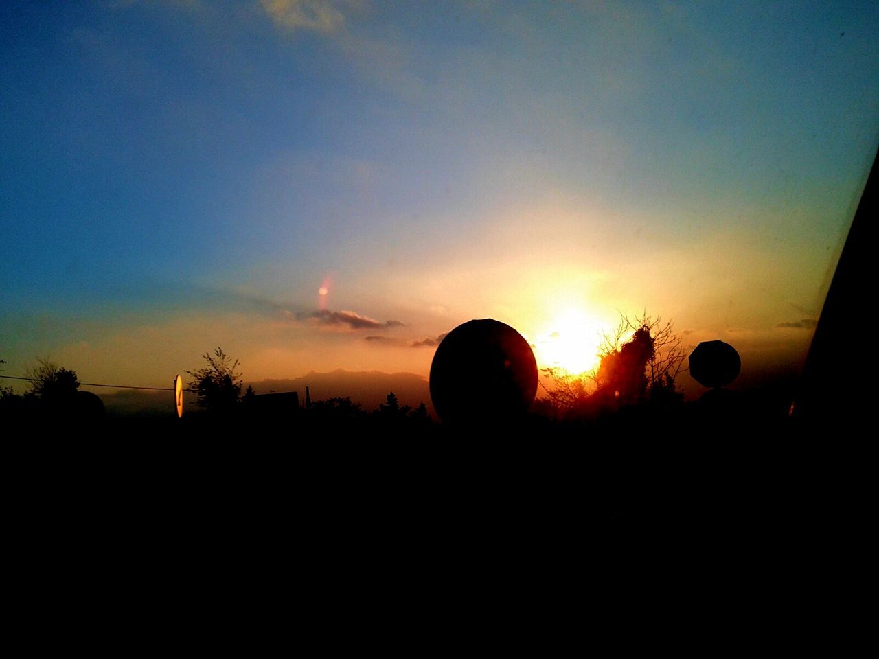 sunset, silhouette, sky, scenics, orange color, beauty in nature, tranquil scene, tranquility, landscape, nature, copy space, dark, sun, idyllic, outdoors, cloud - sky, cloud, moody sky, field, no people