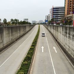 Empty road with buildings in background