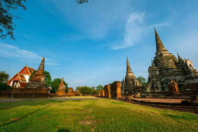 Temple by building against sky