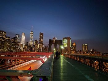 Illuminated cityscape against sky at night