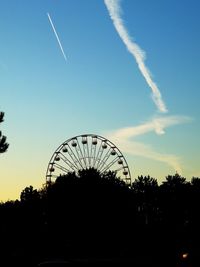 Silhouette ferris wheel against sky at sunset