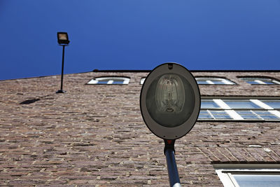 Close-up of street light against clear blue sky