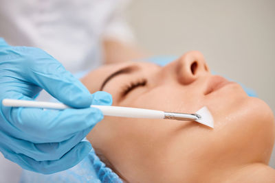 Midsection of dentist examining patient at clinic