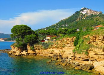 Scenic view of sea and buildings against sky