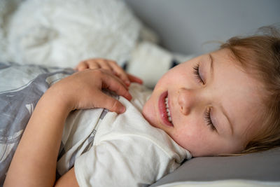 High angle view of woman sleeping on bed at home