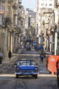 Vehicles on road along buildings