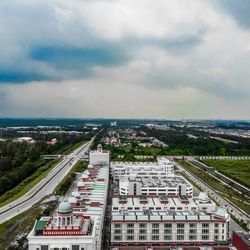 High angle view of road by buildings against sky