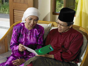 High angle view of couple reading greeting card at home