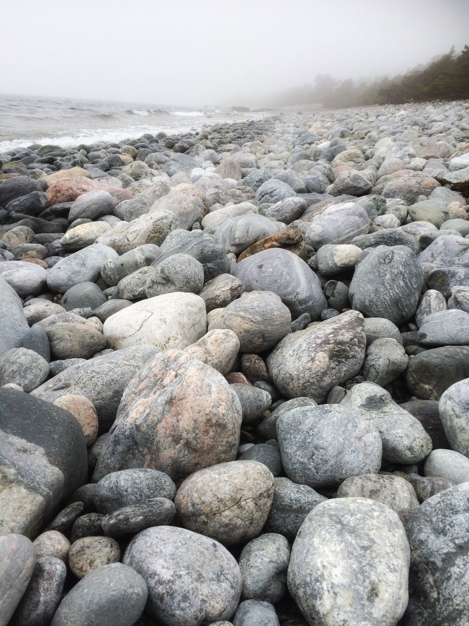 stone - object, abundance, large group of objects, pebble, rock - object, textured, nature, stone, tranquility, stack, tranquil scene, sky, day, outdoors, no people, scenics, beauty in nature, heap, surface level, backgrounds