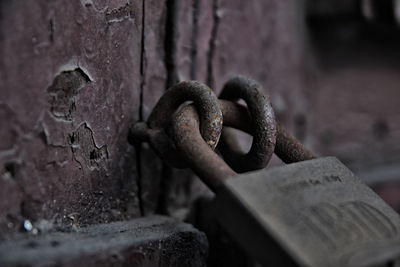 Close-up of padlock on old door