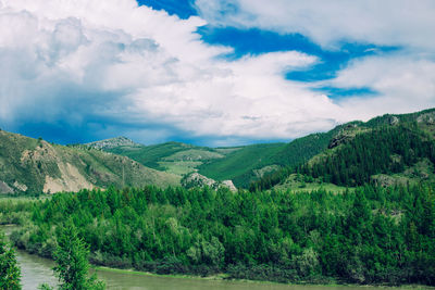 Scenic view of field and mountains against sky