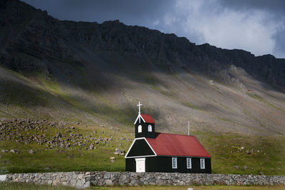 Church by mountain against sky