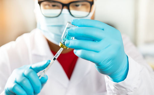 Close-up of human hand holding eyeglasses