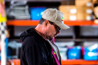 Close-up of man in cap standing at shop