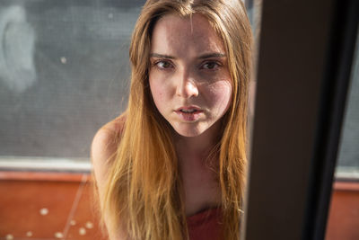 Close-up portrait of young woman with blond hair