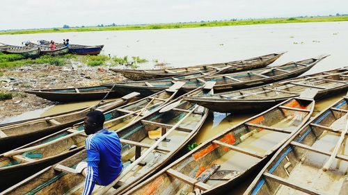 People working in boat against sky