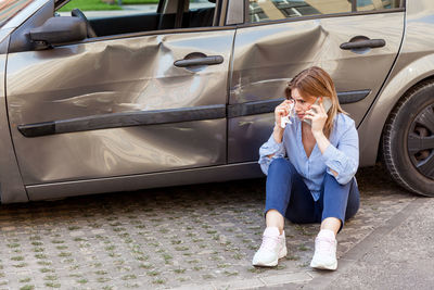 Full length of woman sitting in car