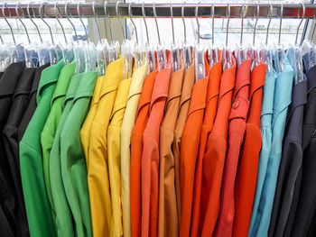 Multi colored clothes hanging in store