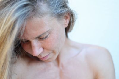 Close-up of woman against white background