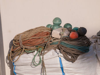 Close-up of rope and buoy against wall