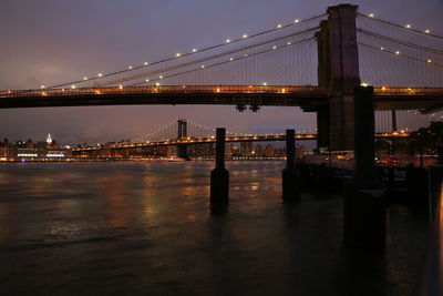 View of suspension bridge in city at night