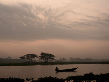 Scenic view of river against sky during sunrise 