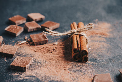 Close-up of chocolate and cinnamon on table