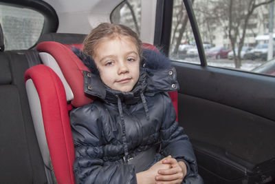 Portrait of girl sitting in car