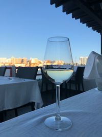 Glass of table at restaurant against clear sky