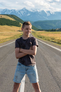 Portrait of young man standing on road