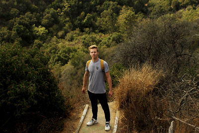 Portrait of young man standing on land